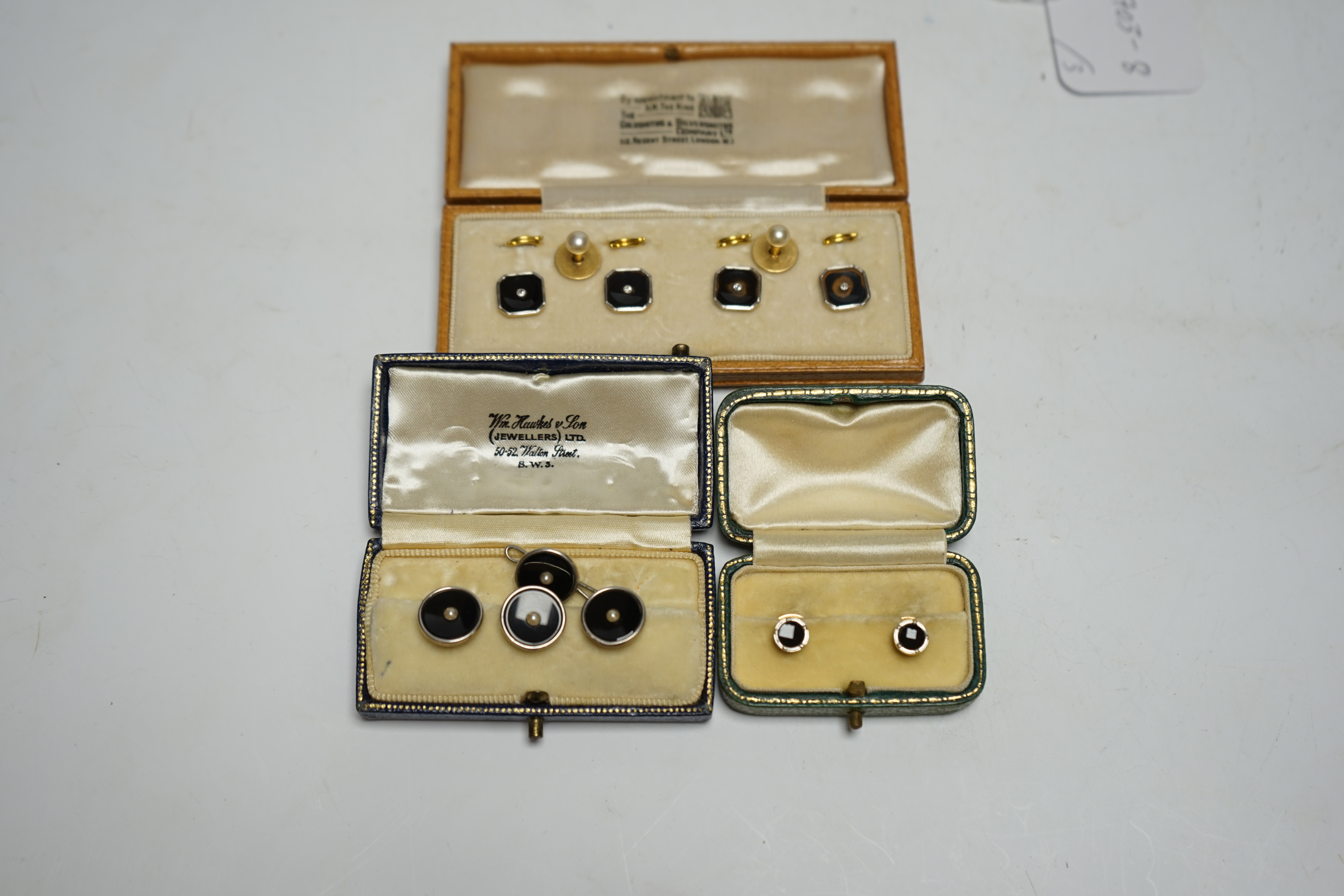 A cased set of four 18ct and plat. black onyx? and diamond set dress studs, two 18ct and cultured pearl set dress studs, four 9ct and plat. black onyx and seed pearl set dress studs and one other pair of 9ct and black on